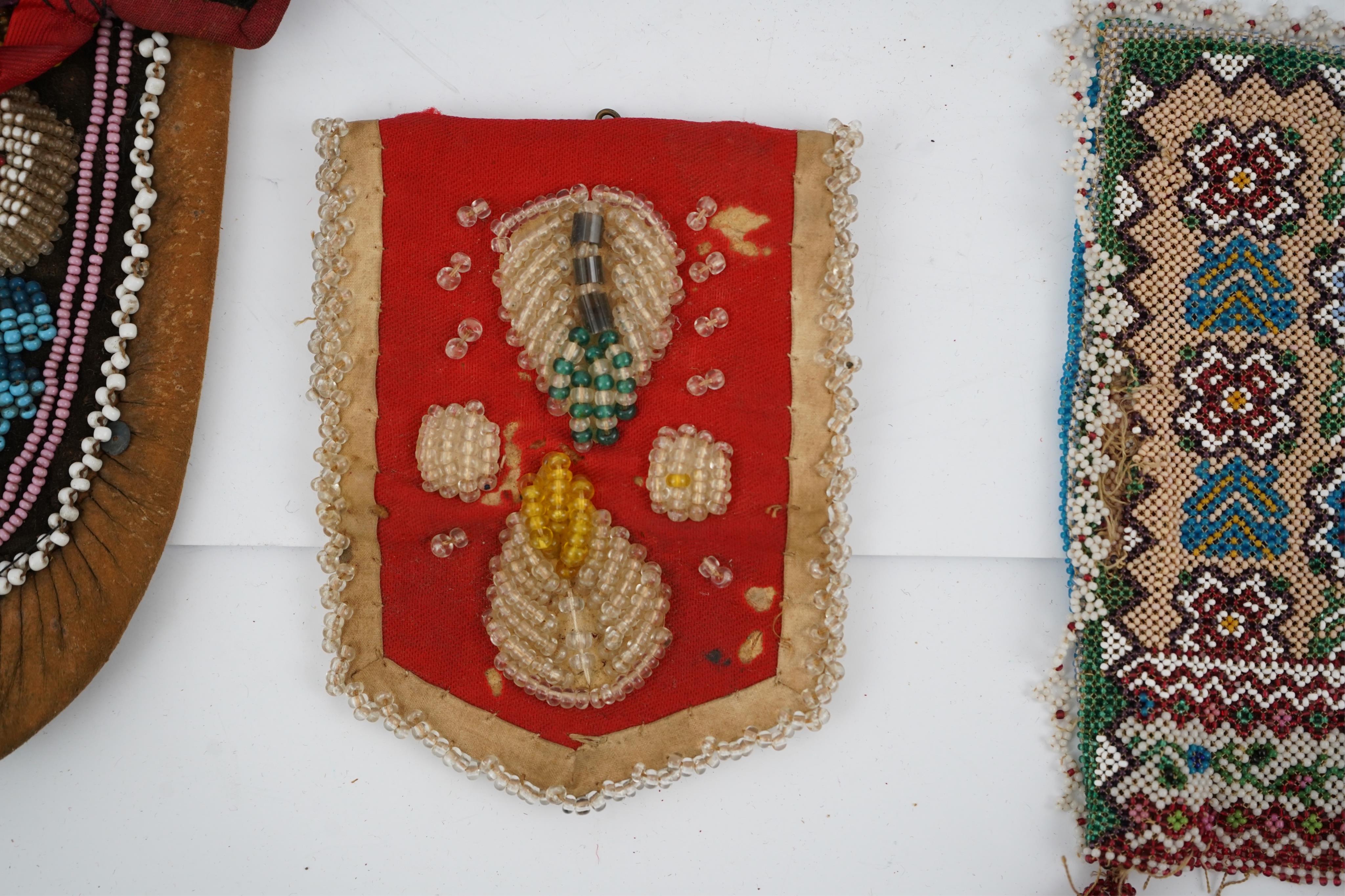 A collection of mixed decorative bead work, including five items of Native American beadwork, together with an early beadwork bag and later beaded items. Condition - moccasins, bead panel, circular bed purse with metal l